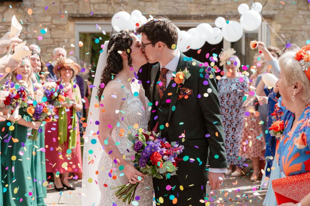 The Frogmill wedding venue Cheltenham Cotswolds Gloucestershire couple surrounded by colourful confetti