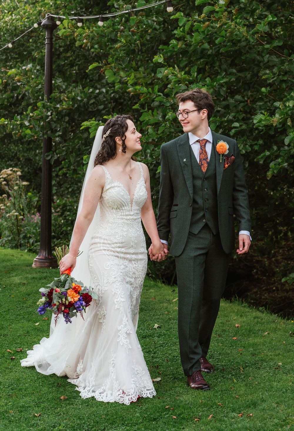The Frogmill wedding venue Cheltenham Cotswolds Gloucestershire Bride and Groom on front lawn by stream