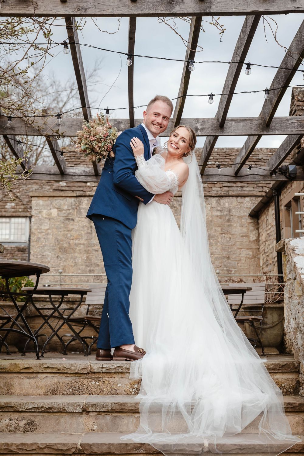 The Frogmill wedding venue Cheltenham Cotswolds Gloucestershire couple on stairs outside mill room