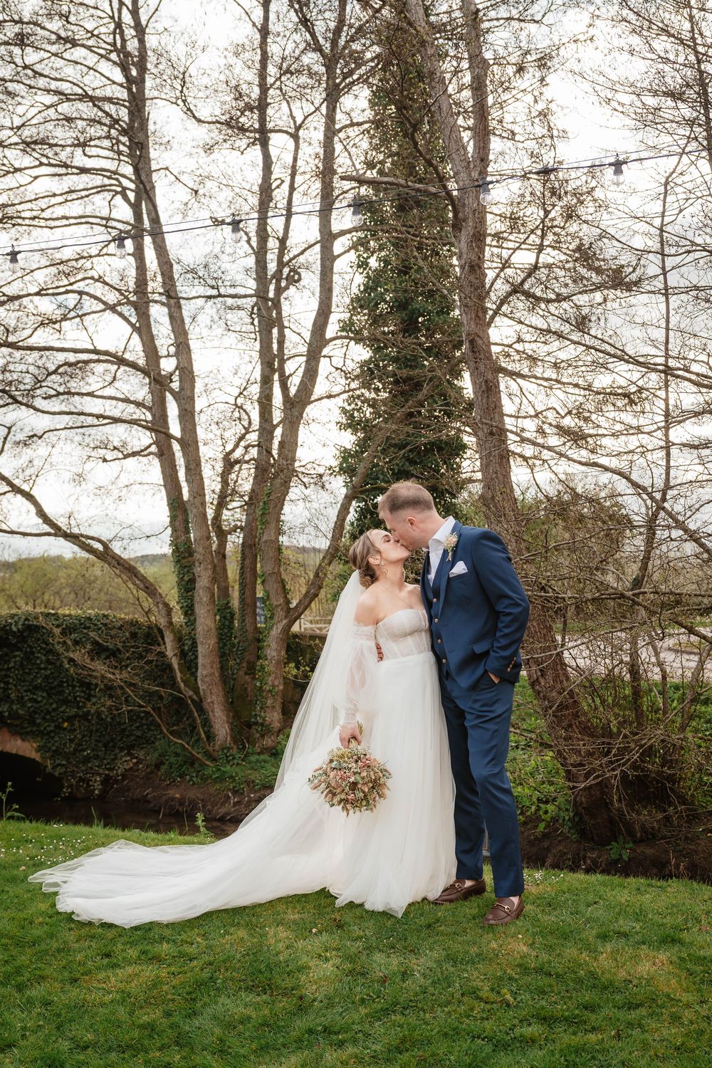 The Frogmill wedding venue Cheltenham Cotswolds Gloucestershire April wedding couple in front of bare trees