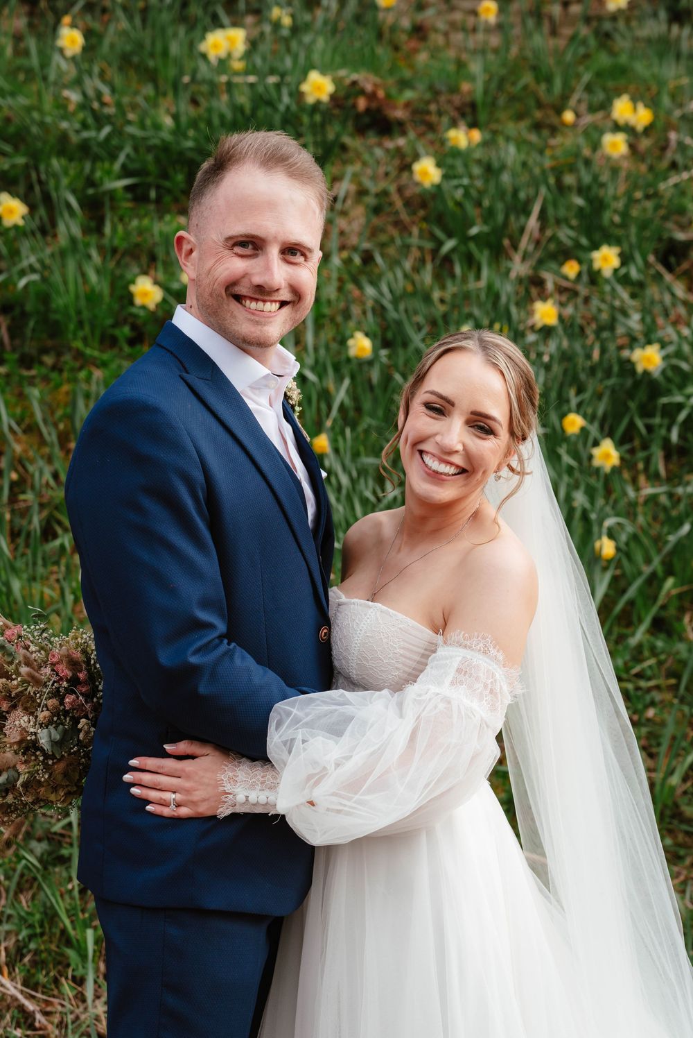 The Frogmill wedding venue Cheltenham Cotswolds Gloucestershire couple in front of daffordils april wedding