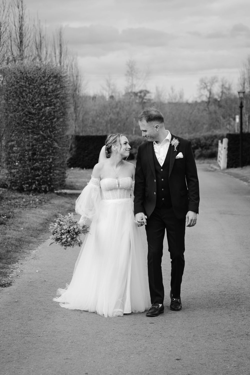 The Frogmill wedding venue Cheltenham Cotswolds Gloucestershire black and white of couple on driveway