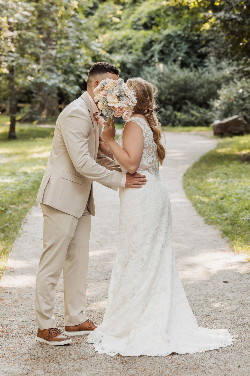 A romantic sequence of wedding couple moments captured on a garden path in matching khaki and white attire.