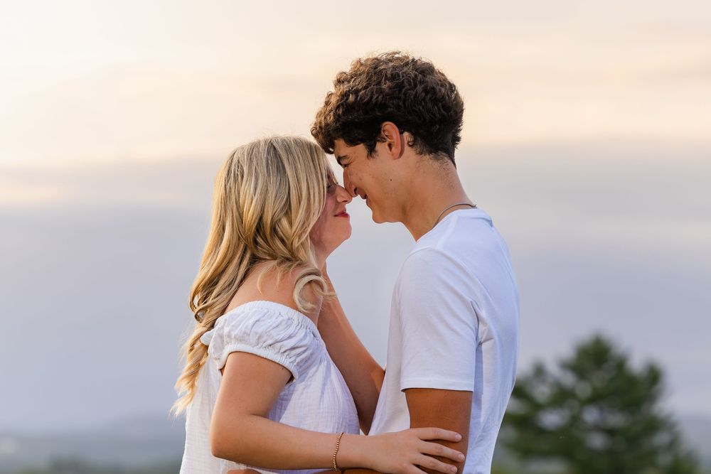 A couple shares a romantic moment at sunset on a beach with multiple intimate poses captured in a photo collage.