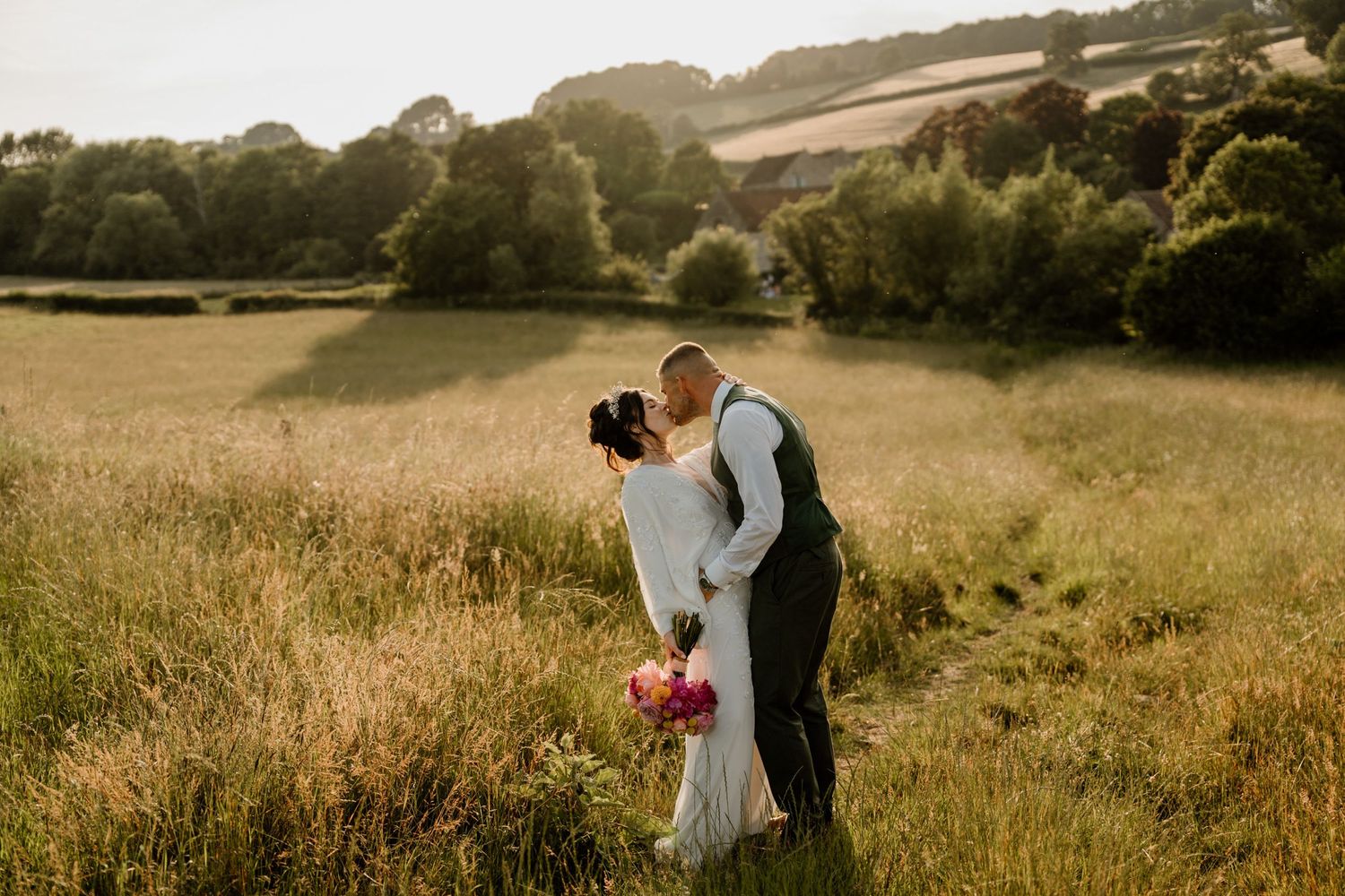 Golden sunset view of rolling hills and countryside at outdoor wedding venue.
