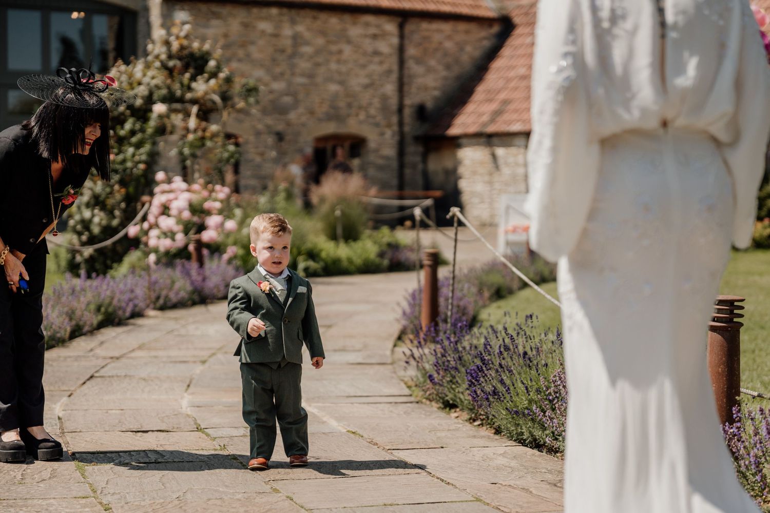 Garden wedding venue with stone pathways surrounded by blooming summer flowers.