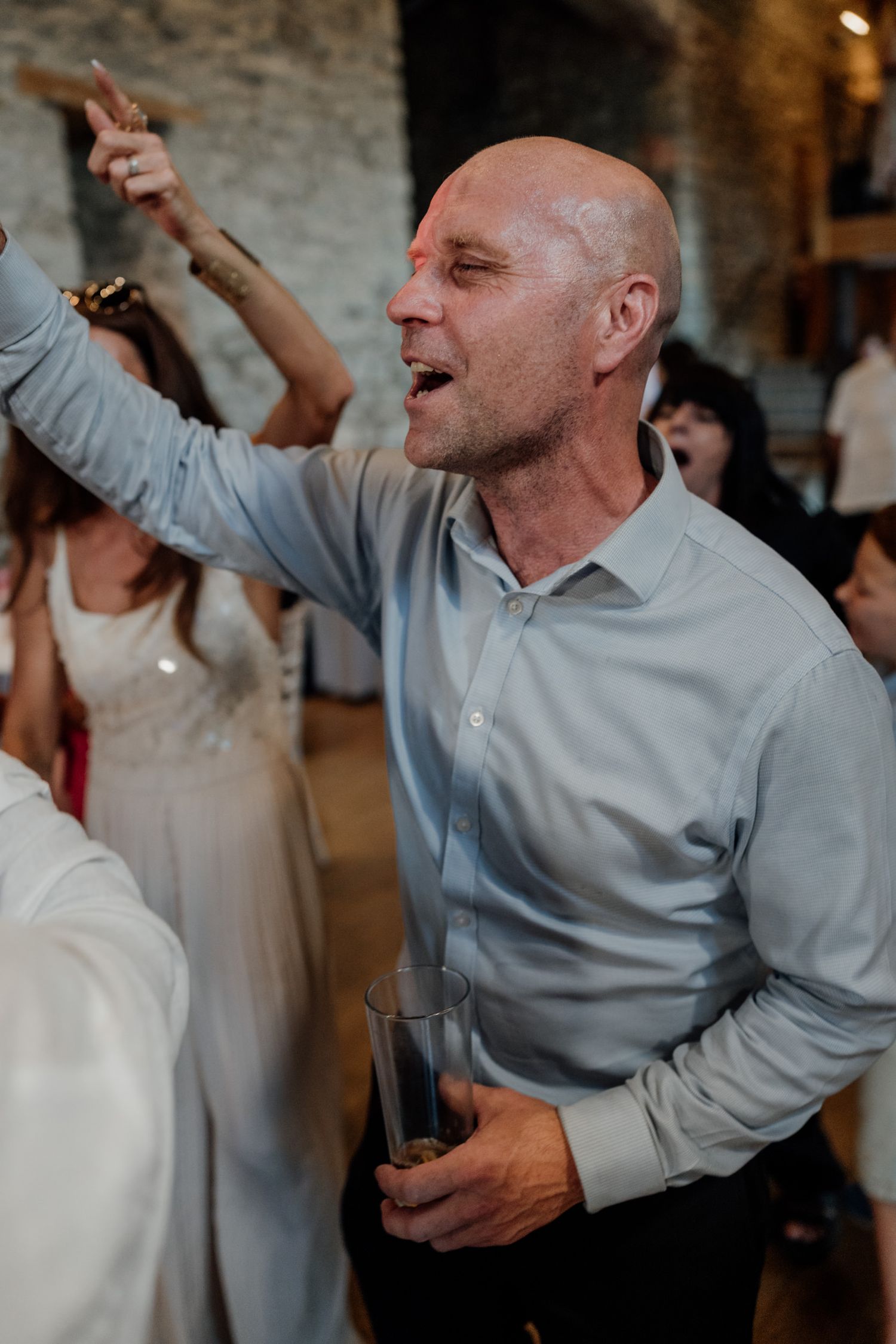 A sequence of joyful dancing moments captured during a wedding reception celebration.