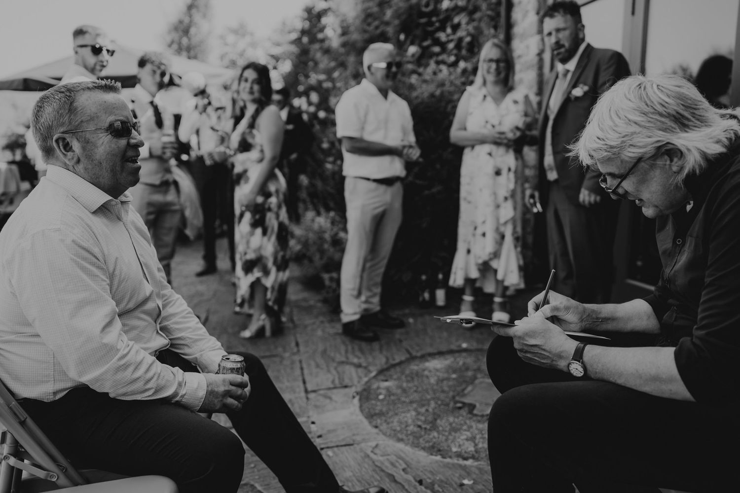 Guests enjoying a lively outdoor wedding reception at dusk.