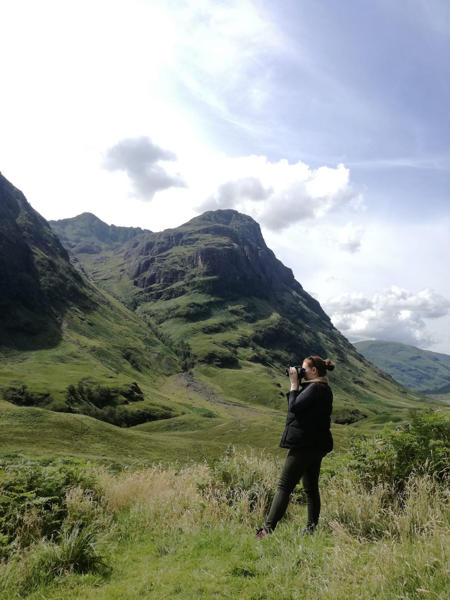 candid image of a photographer taking pictures in glencoe, Scotland