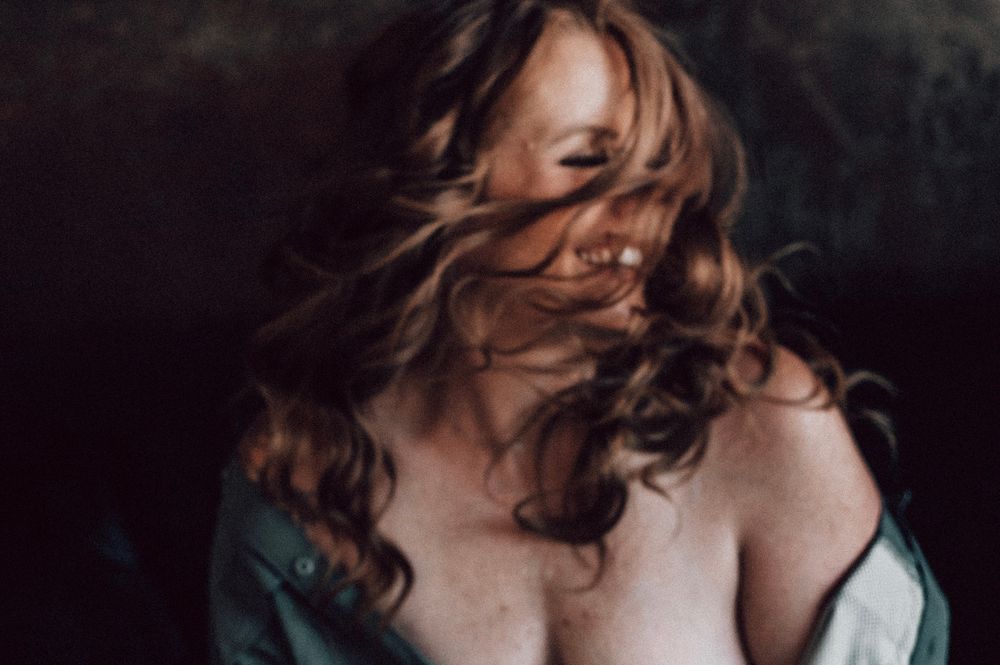 Artistic portrait series showing dramatic lighting and hair movement against dark background.