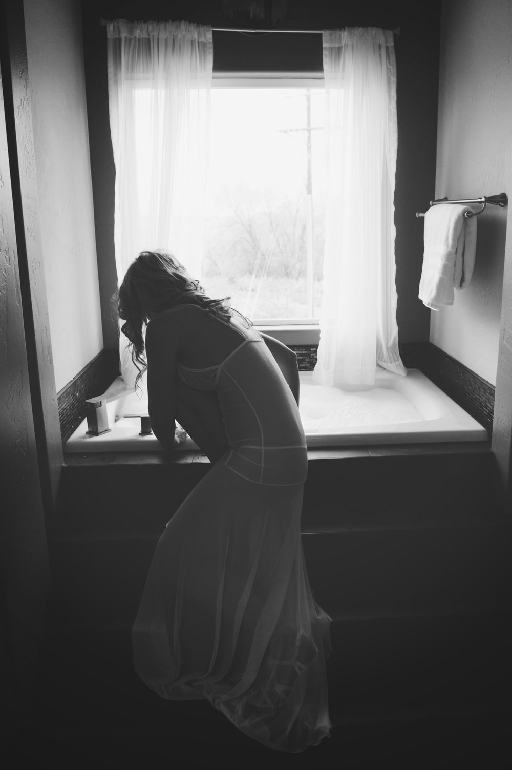 Moody black and white window portraits with silhouette casting shadows.