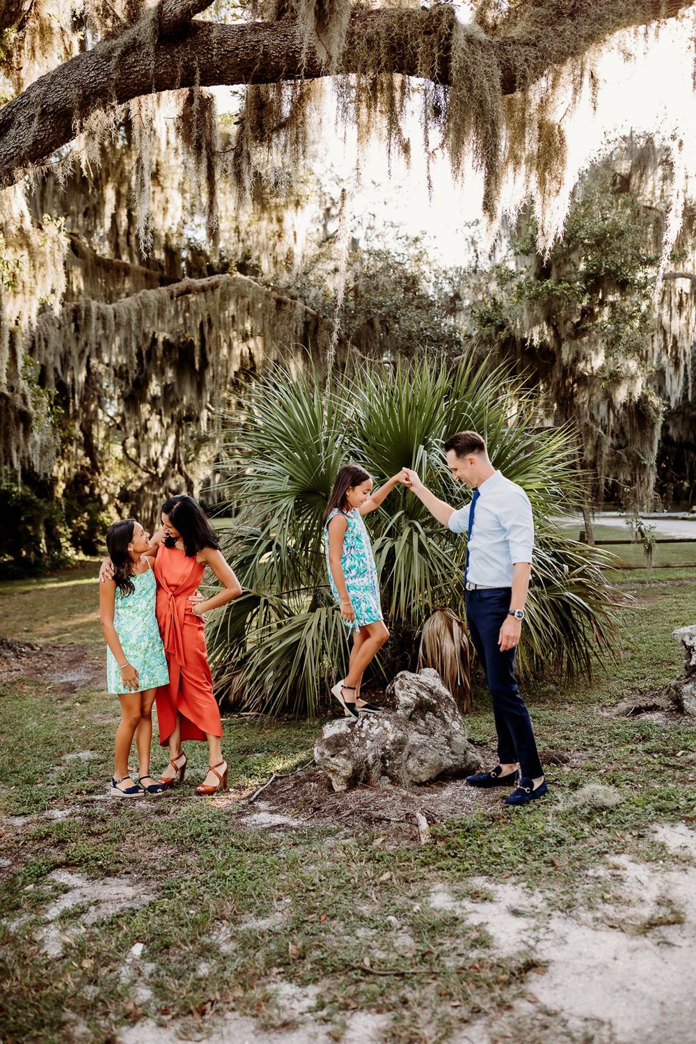 A romantic sequence of photos showing a couple dancing together under Spanish moss draped trees in a natural setting.