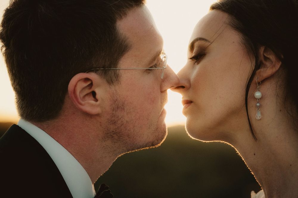A romantic wedding photo sequence silhouetted against golden sunset light.