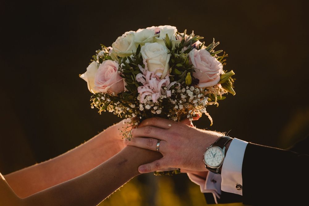 A delicate pink and white bridal bouquet with roses and baby's breath.