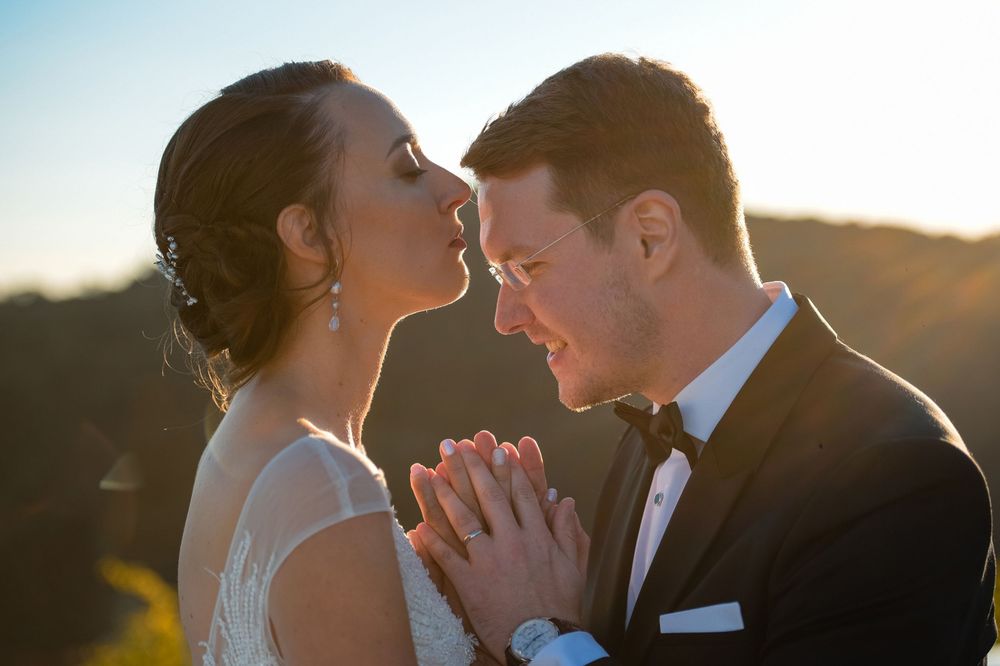 Golden hour wedding photography showing intimate moments between a couple.