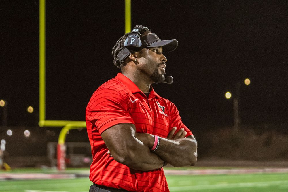 Football coach looking onto field