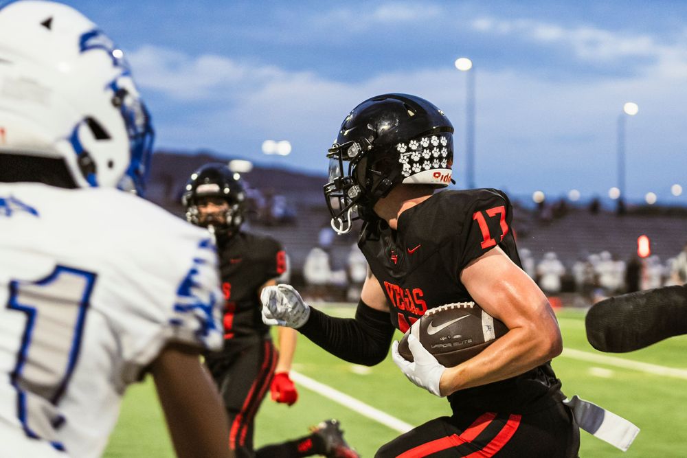 Football player running off left frame