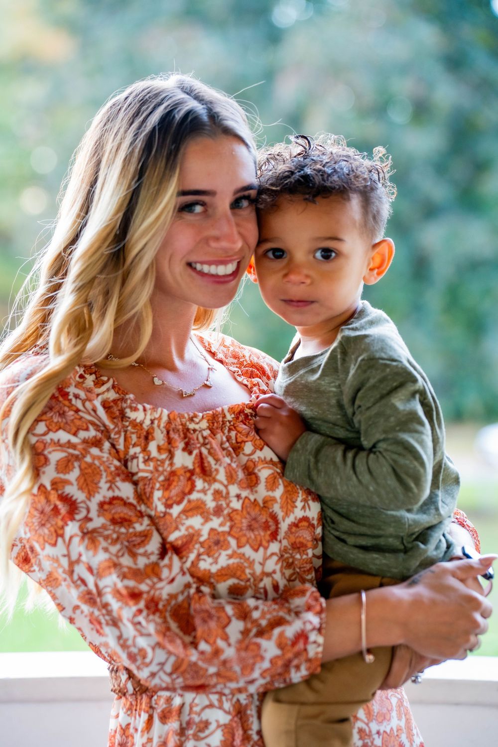 Family portrait session outdoors with floral dress and olive green clothing.