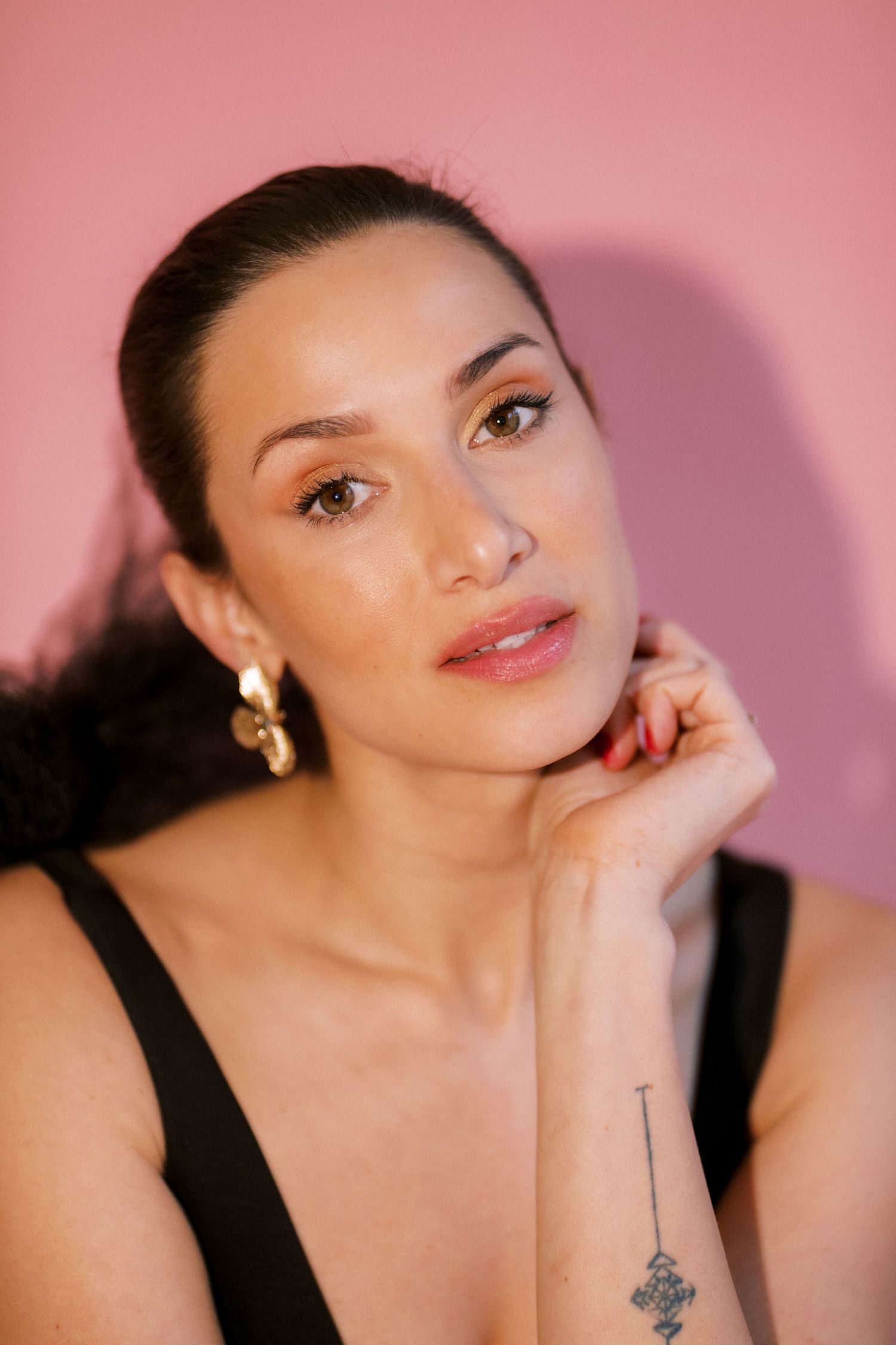 A series of beauty portraits against a pink background featuring glamorous makeup and dramatic poses.