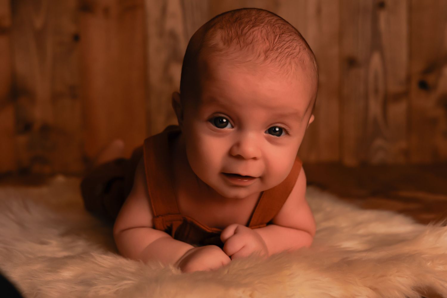 Professional studio portraits showing joyful expressions on pink background.