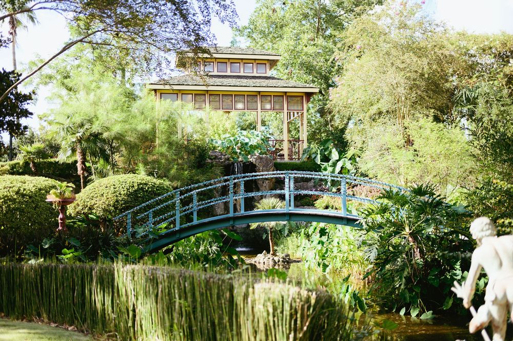 A series of garden views show a Japanese-style bridge over a pond surrounded by lush greenery and flowering plants.