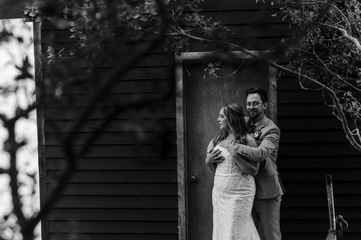 Black and white photos of a romantic and elegant outdoor wedding ceremony with guests posed throughout a garden setting.