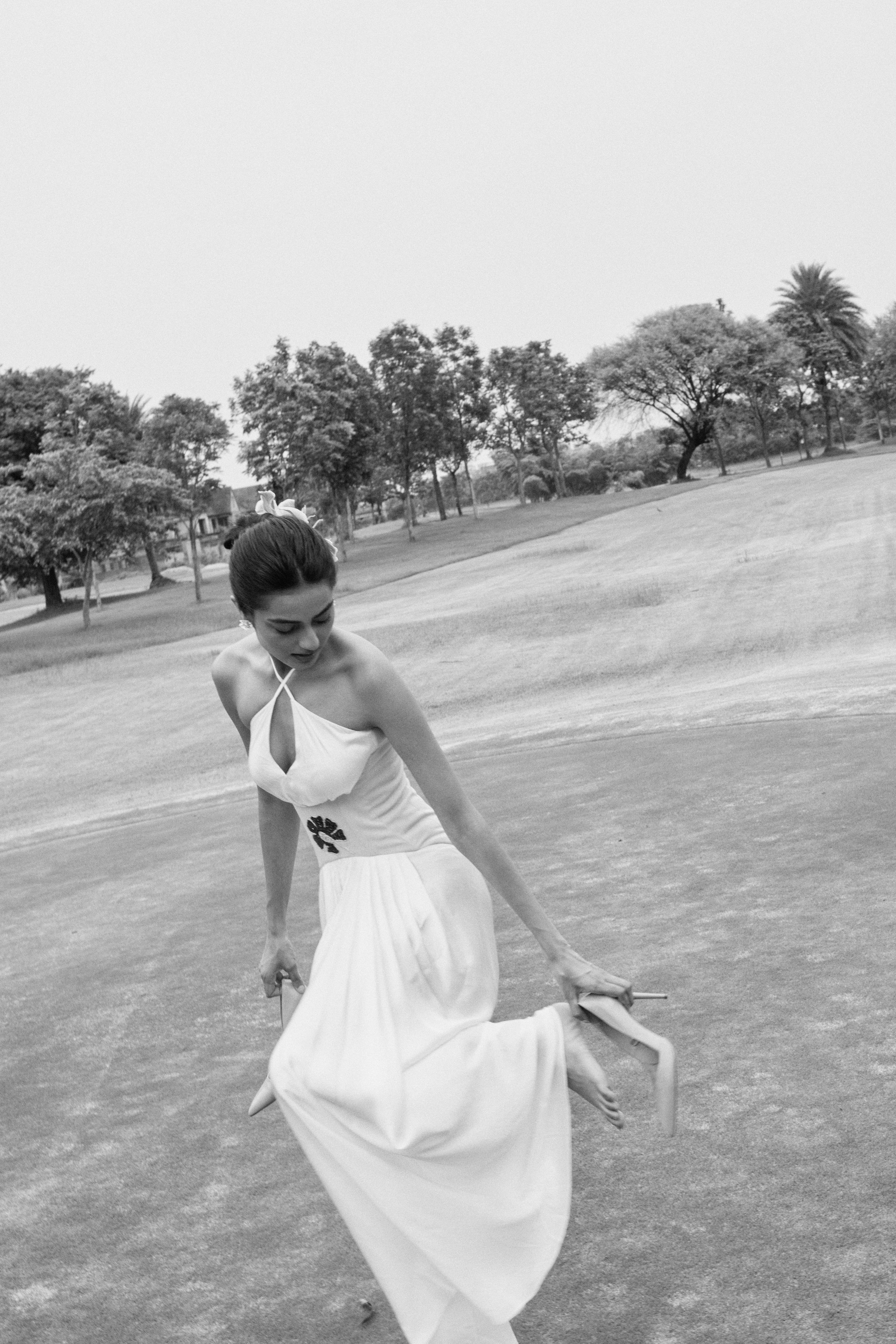 Black and white portrait of a model in a structured dress