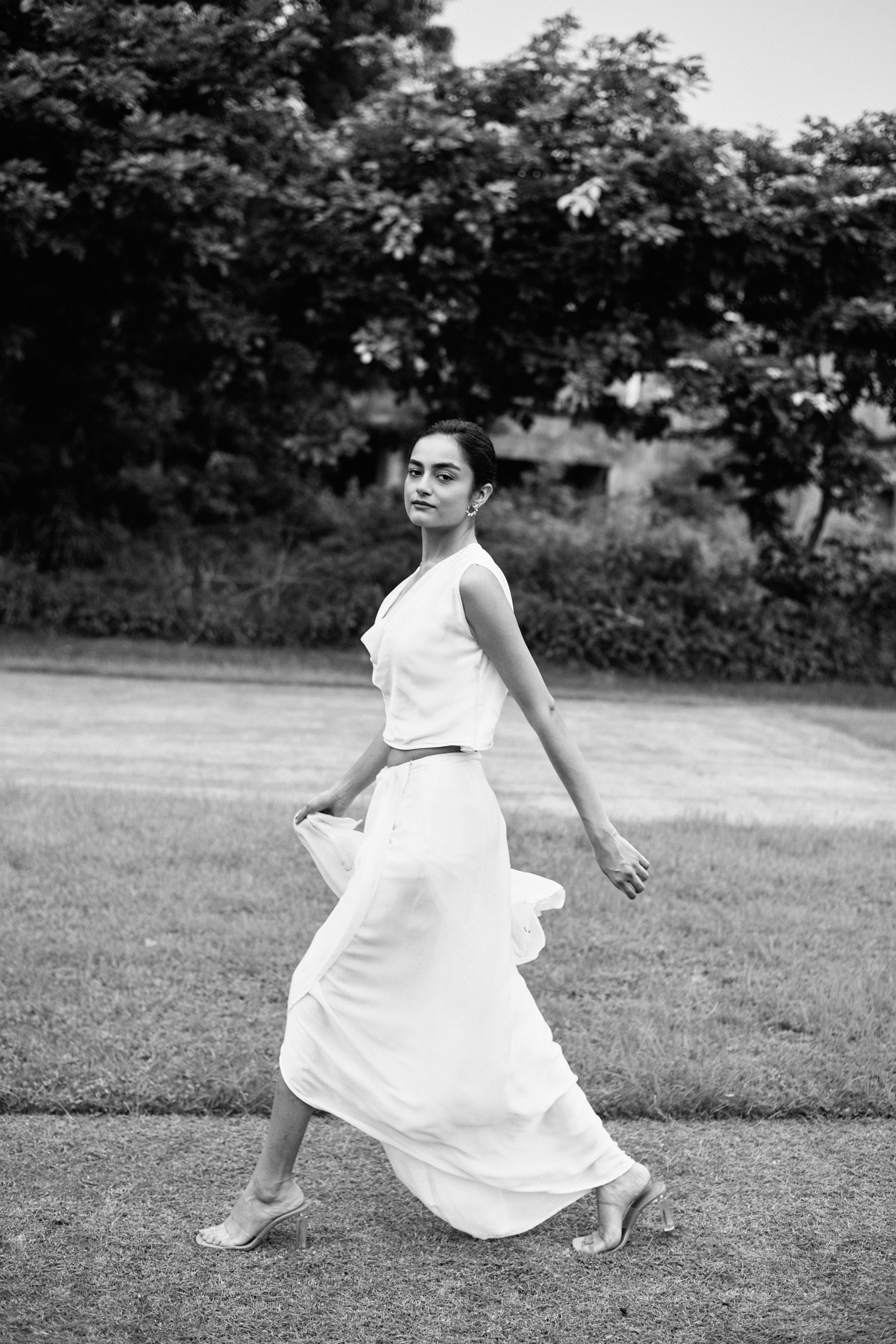 Close-up fashion portrait emphasizing facial expression, contrast, and modern monochrome elegance.