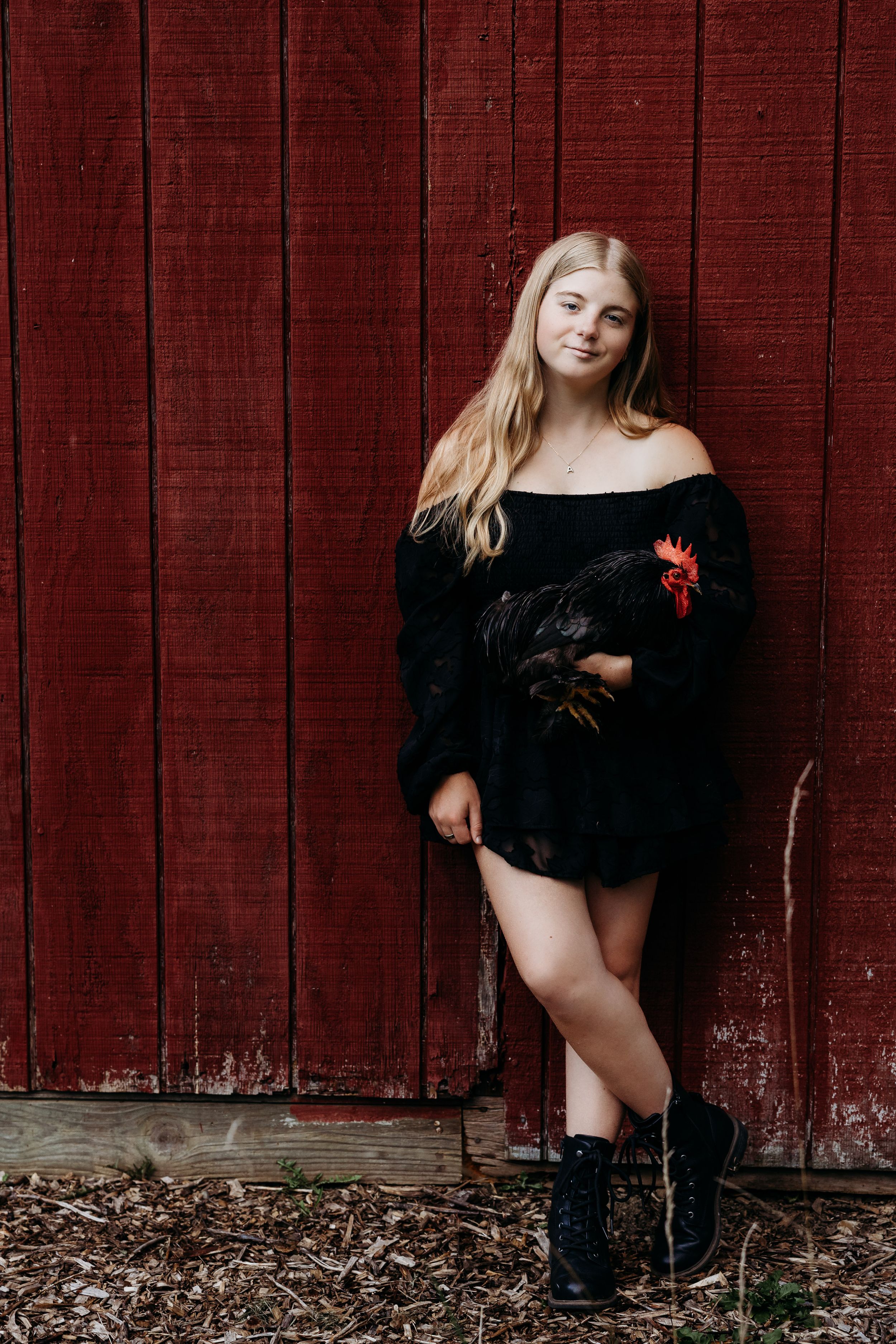 A woman in a black dress poses against a rustic red barn wall in a creative photo collage.