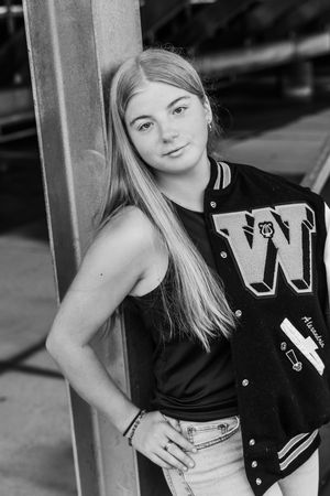Black and white portraits showing athletic students wearing varsity jackets near stadium seating.