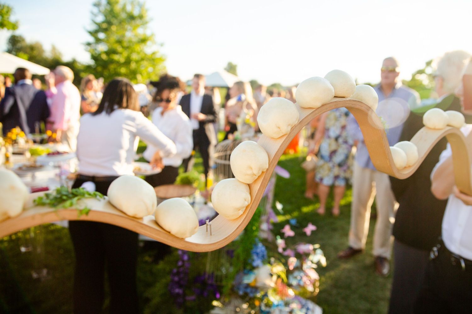 String of glowing lights decorating outdoor wedding celebration.