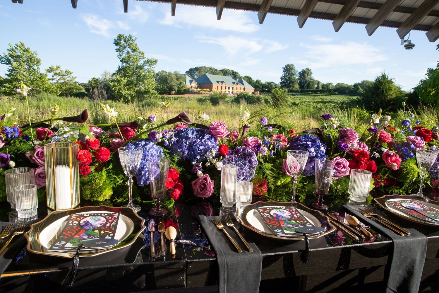 Elegant wedding reception table setting adorned with colorful floral arrangements and vintage decor.