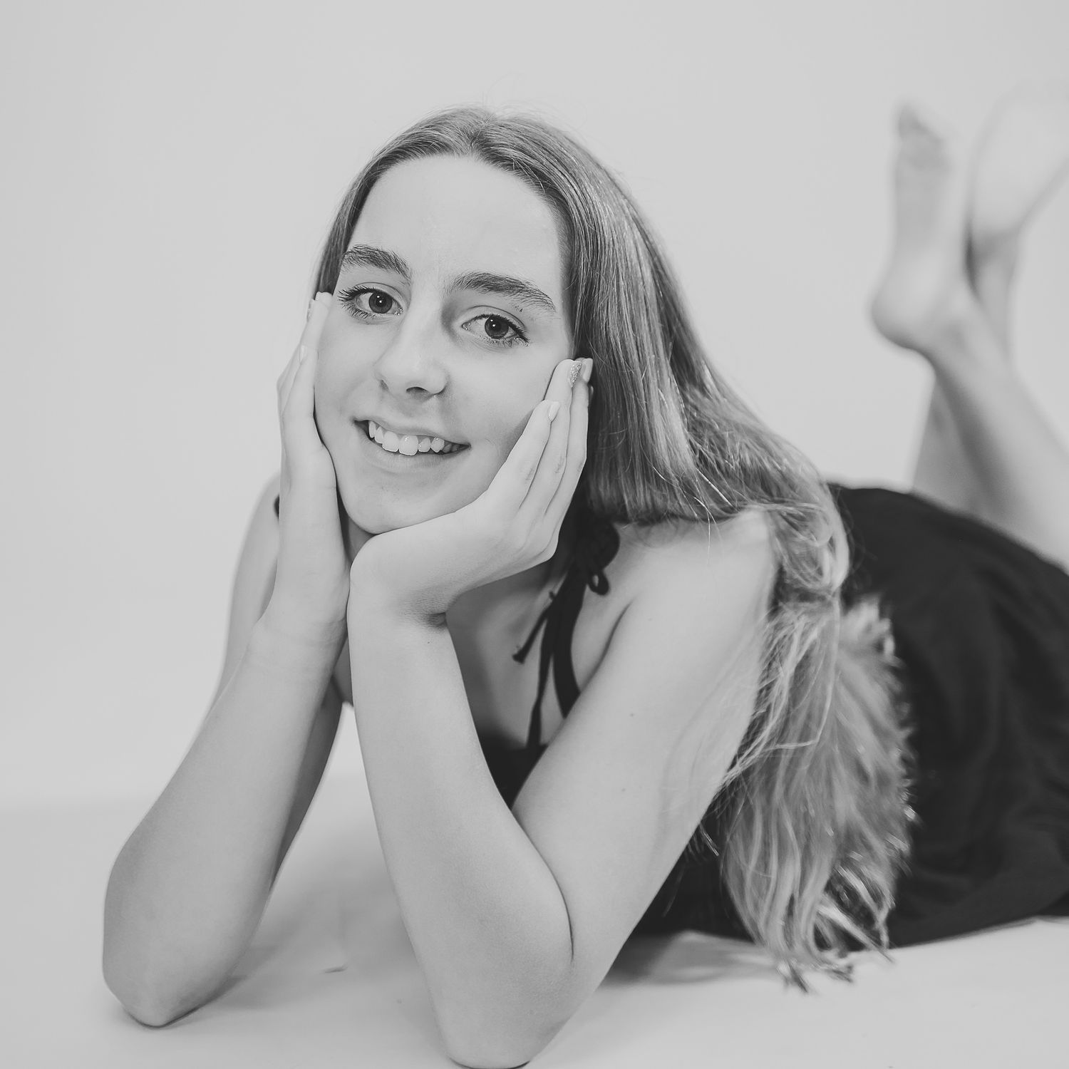 Intimate black and white portrait series with relaxed poses on light background.