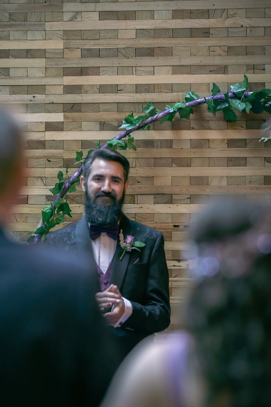 A sequence of photos showing someone with a dark beard against a brick wall with green foliage in the upper corner.
