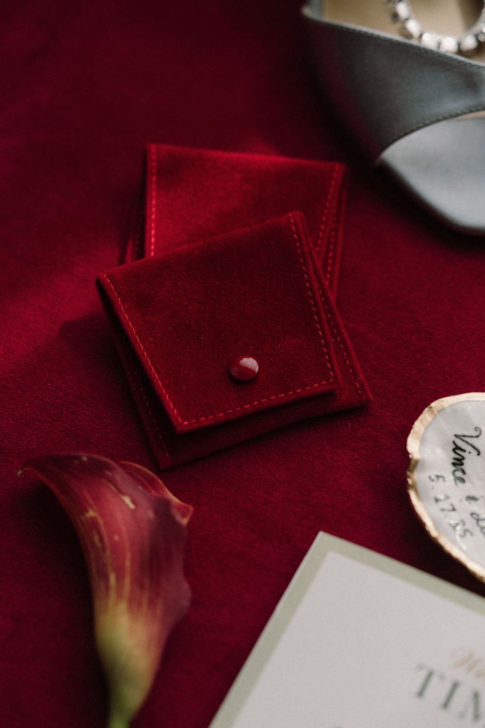 Red velvet fabric textures shown in close-up detail with crisp edges and deep crimson tones against a white backdrop.