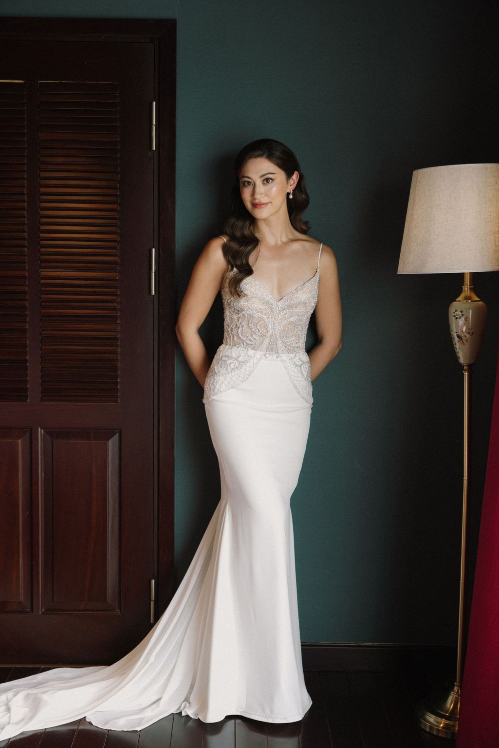 Elegant white chiffon wedding dress with sweetheart neckline and lace detailing shown against dark walls in a triptych view.