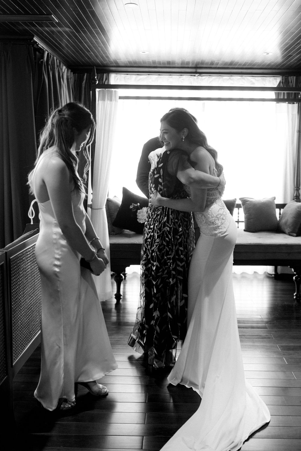 Intimate dance sequence between two people in a bright indoor space with dark curtains.