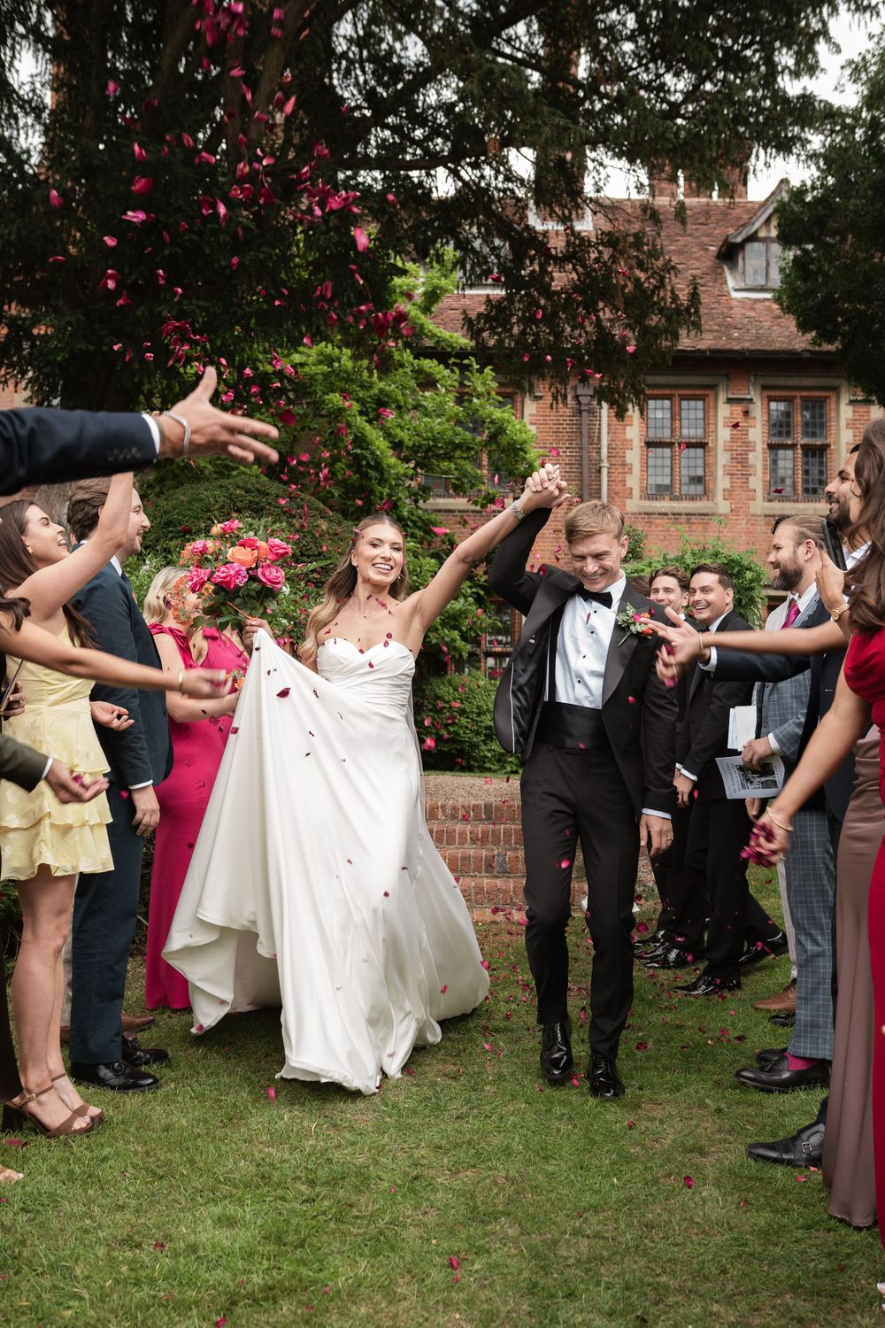 A wedding party celebrates outdoors by throwing rose petals in a sequence of joyous moments captured in multiple frames.