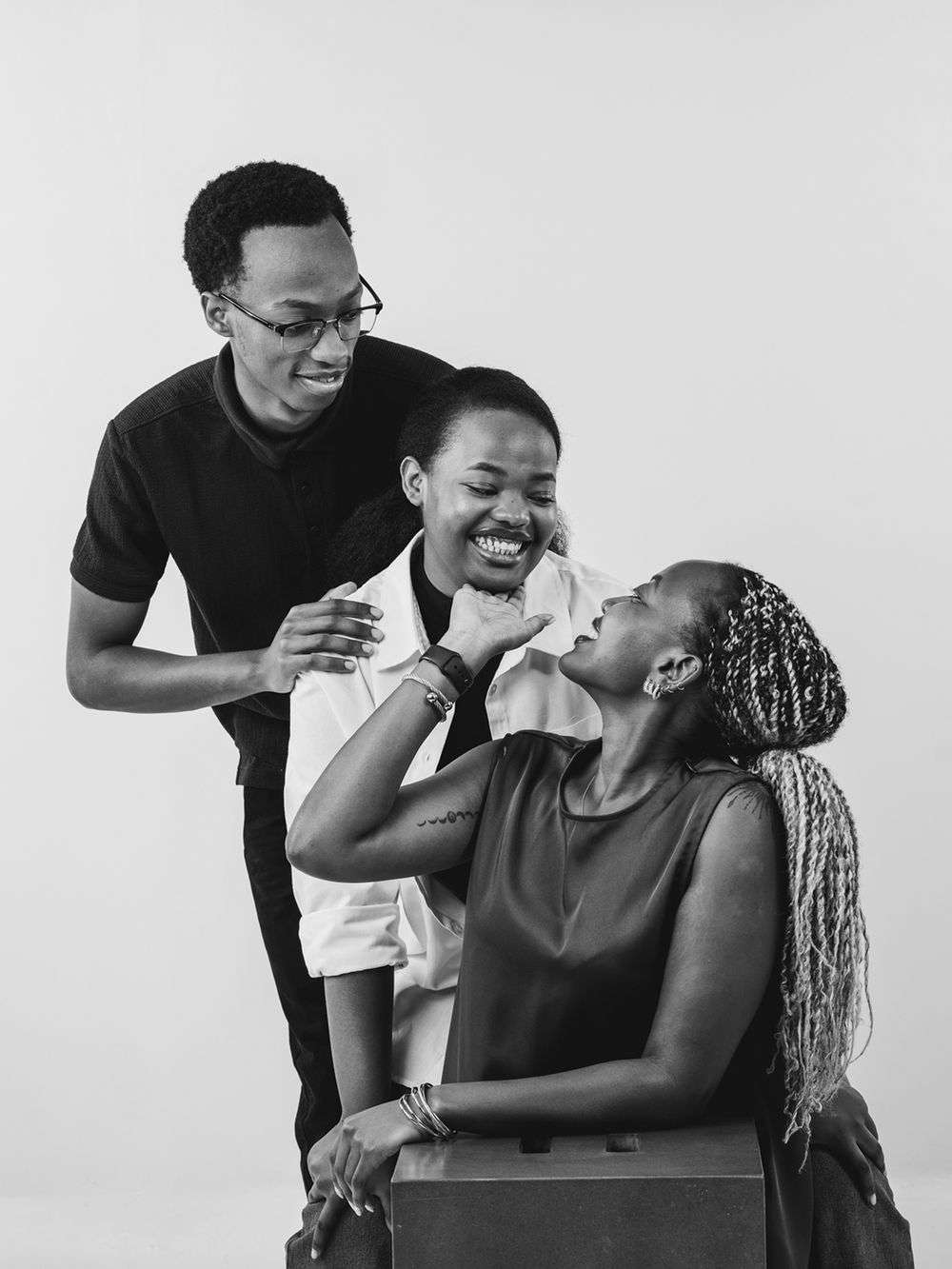 Artistic black and white portraits showing dynamic interactions and laughter between multiple people.
