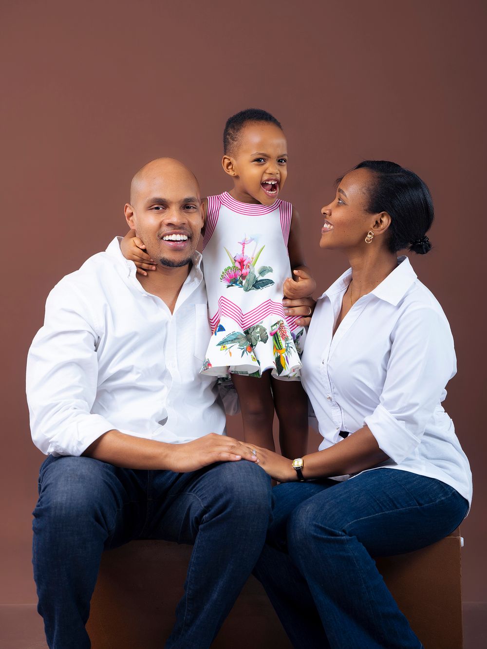 Three heartwarming moments with a small child and adults wearing matching white shirts and jeans on brown background.