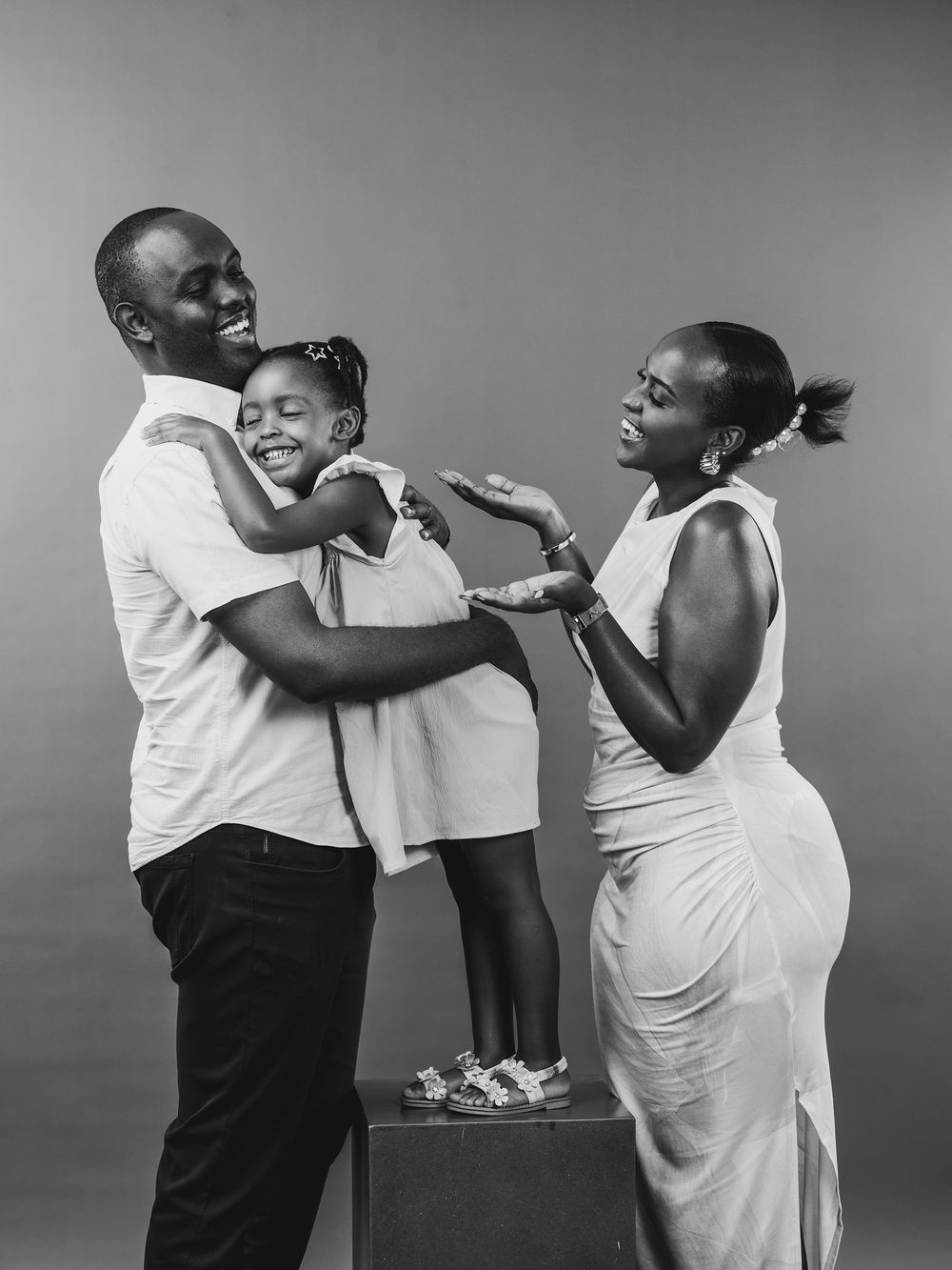 Four black and white sequential images show two people having a playful physical interaction while wearing casual clothing.