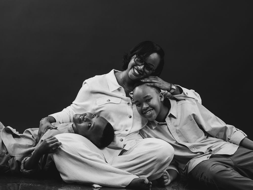 A candid black and white photograph capturing a tender moment of shared laughter and relaxation.