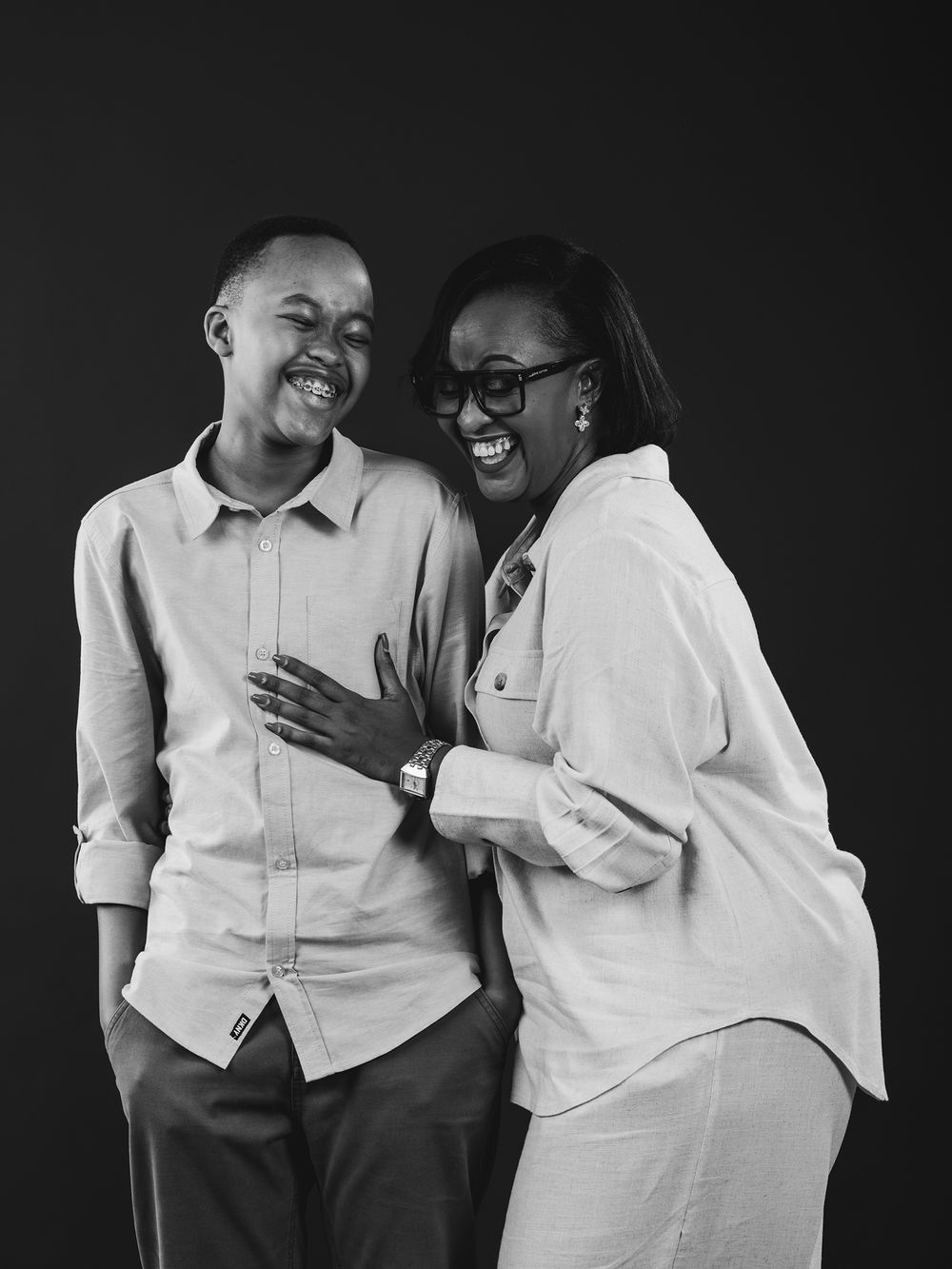 A series of black and white photographs showing a couple laughing together while wearing white shirts.