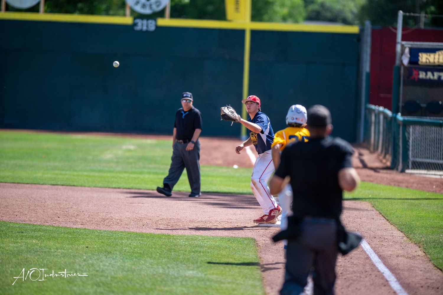 Baseball pitch flying through the air against a green field backdrop during a game.
