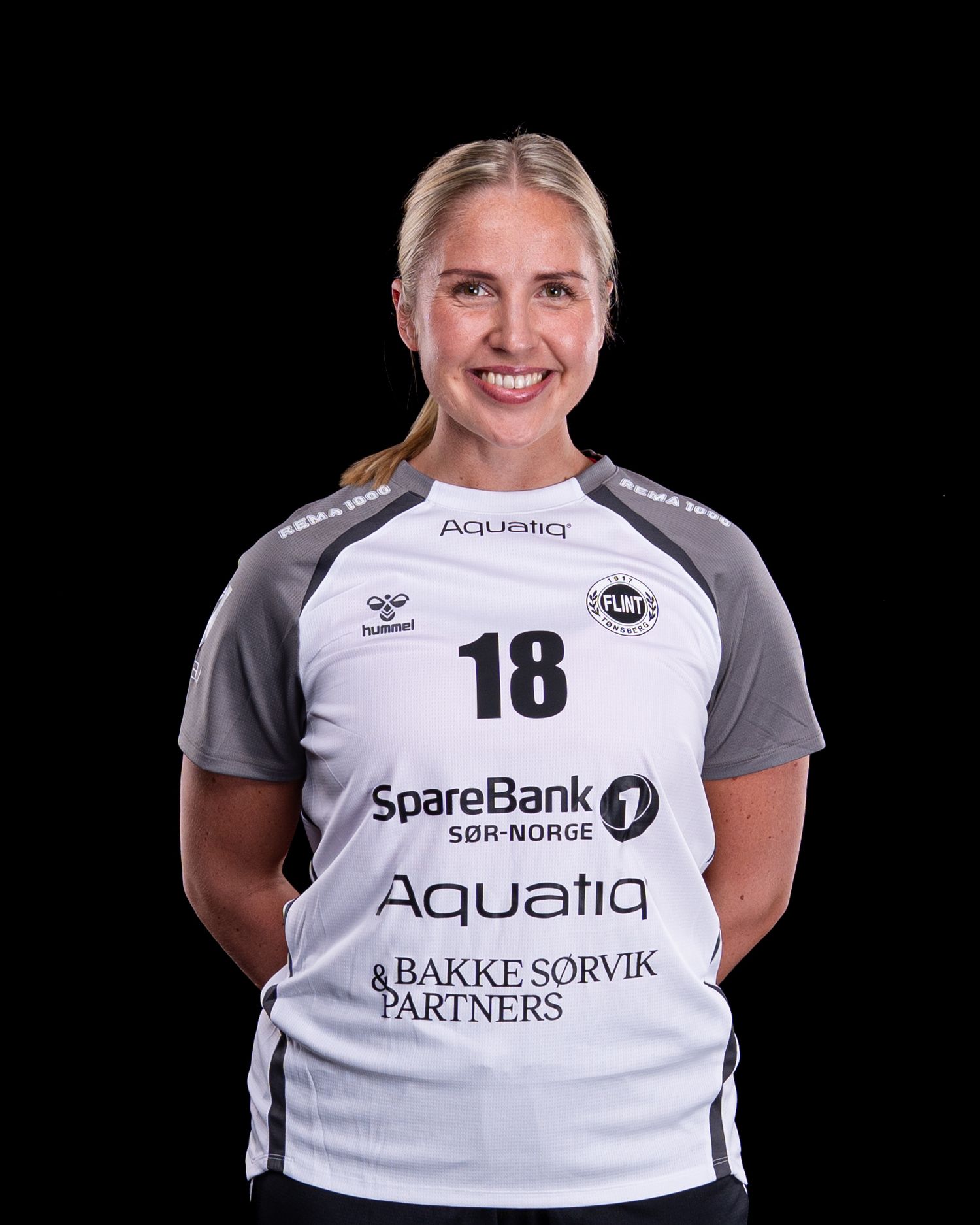 Soccer team player headshots showing athlete wearing white team jersey with sponsor logos and number 18.