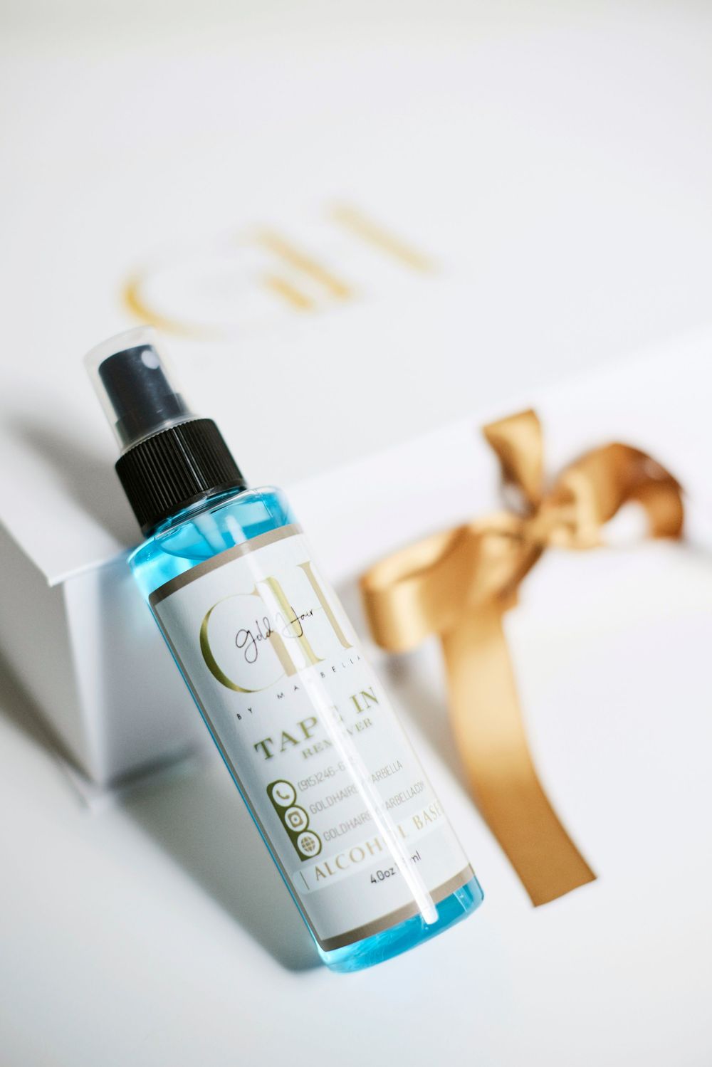 Hair care product bottles with blue liquid and gold accents on white background.