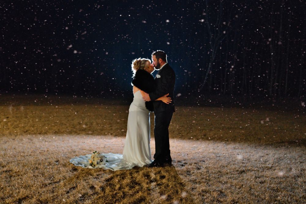 Winter wedding scene with glittering snowfall effect and dark romantic atmosphere.