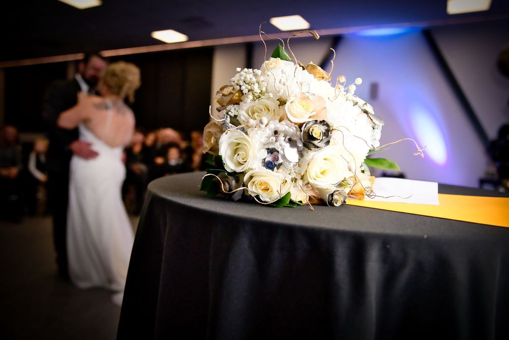 Wedding reception venue with blue uplighting and elegant table settings.