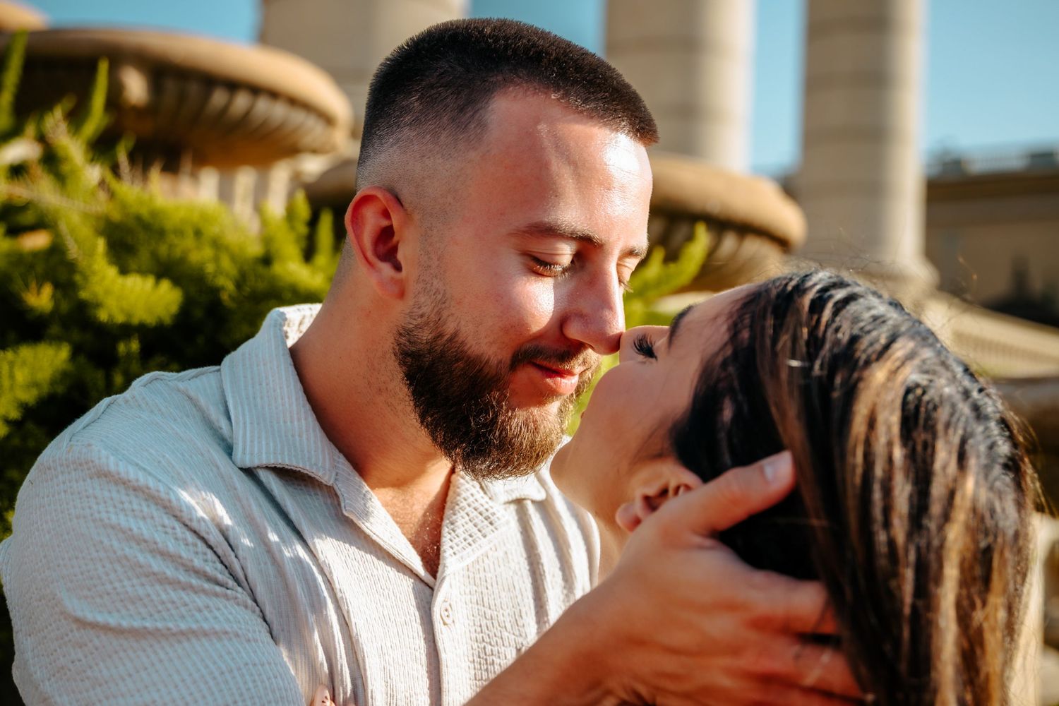 Couple holding hands tenderly in the summer glow.