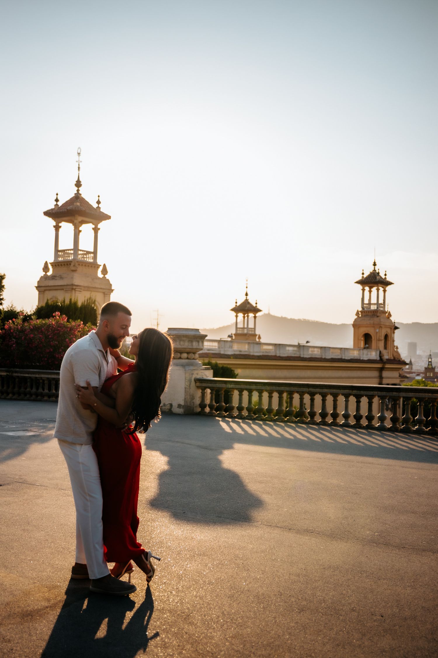 Tender embrace captured against sweeping city views of Barcelona.